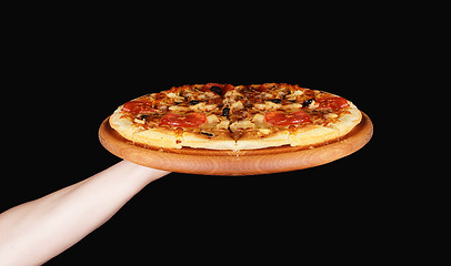 Image showing Tasty pizza in wooden plate