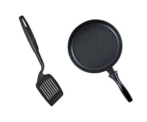 Image showing Pan with black plastic kitchen spatula