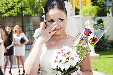 Image showing Emotional bride holding floral bouquet bridal