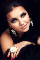 Image showing brunette girl posing in studio on dark background