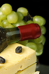 Image showing Grape wine with cheese on black