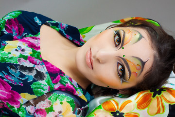 Image showing young girl lying with beautiful make up on her face