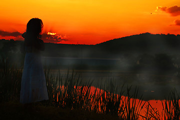 Image showing Girl in red sunset