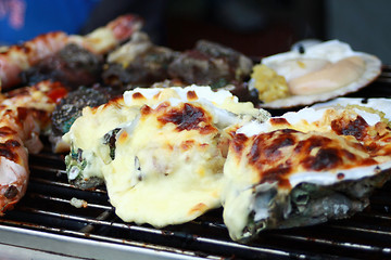 Image showing Cooking oysters with cheese