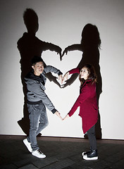 Image showing Asian couple on street making a heart