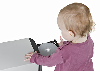 Image showing young child playing with CD