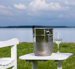 Image showing Garden chair and champagne by Chesapeake bay