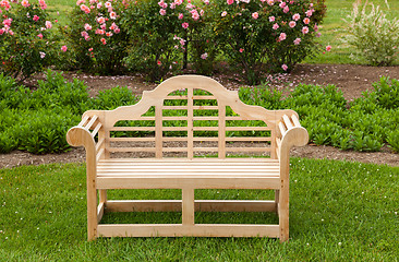 Image showing Teak chair or bench on green lawn