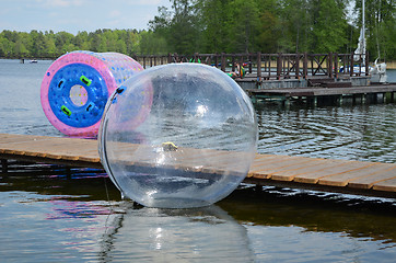 Image showing Zorbing air bubbles on water. Pier lake Trakai 