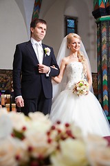 Image showing groom and bride during wedding ceremony in old town hall interior