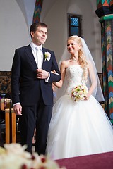 Image showing groom and bride during wedding ceremony in old town hall interior