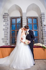 Image showing first kiss of groom and bride during wedding ceremony