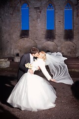 Image showing groom and the bride in stone court yard of castle