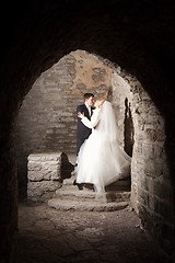 Image showing groom and the bride in interior of medieval castle
