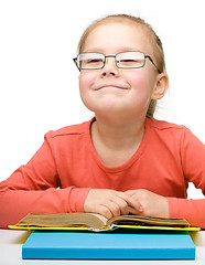 Image showing Cute little girl reading book