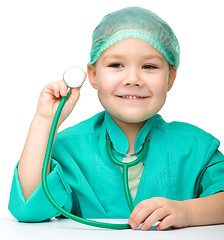 Image showing Little girl is playing doctor with stethoscope