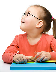 Image showing Cute little girl reading book