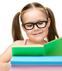 Image showing Cute little girl with books