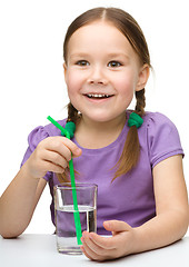 Image showing Cute little girl with a glass of water