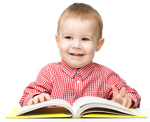 Image showing Little child play with book