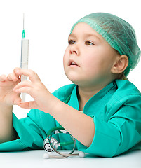 Image showing Cute little girl is playing doctor with syringe