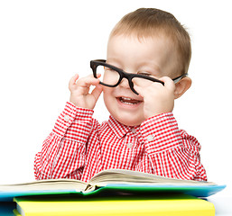 Image showing Little child play with book