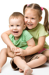 Image showing Two children are having fun while sitting on floor