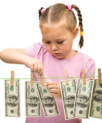 Image showing Cute little girl with paper money - dollars