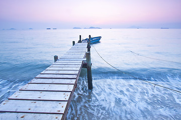 Image showing Jetty sunset along coast with waves movement