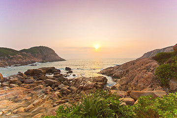 Image showing Sea rocks along the coast under sunrise
