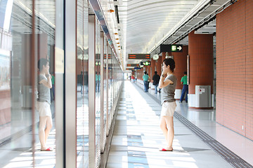 Image showing Asian girl waiting in train station