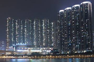 Image showing Hong Kong apartment blocks at night, showing the packed conditio