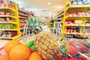 Image showing Moving shopping cart in supermarket. It was taken with a slow sh