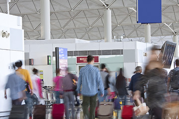 Image showing Fast moving passengers at airport modern building