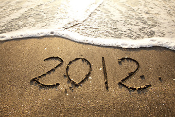 Image showing 2012 written on sand