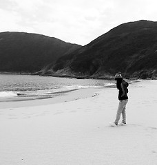 Image showing Asian sad girl on beach 