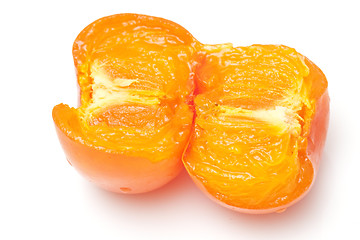 Image showing An opened orange persimmons isolated on white background 