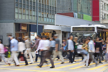 Image showing Moving pedestrian in business district, blurred motion.