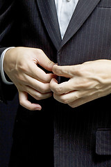 Image showing Business man tidy up his suit's button