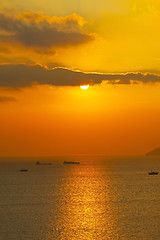 Image showing Sunset over the ocean with moving ships