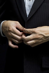 Image showing Business man tidy up his suit's button