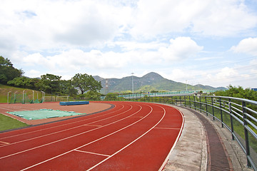 Image showing Sports stadium with running track at day