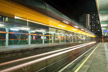 Image showing Light rail in Hong Kong at night, busy traffic. 