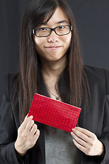 Image showing Chinese business woman holding a Chinese red packet and wishing 