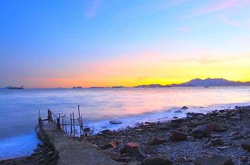 Image showing Sunset along the coast with isolated bridge