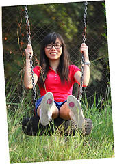 Image showing Asian woman playing swing with happy face