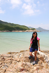 Image showing Hiking girl along the coast