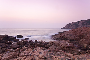 Image showing Sunrise along seashore under long exposure