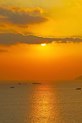 Image showing Sunset over the ocean with moving ships