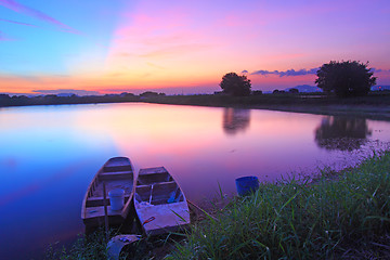 Image showing Isolated boats along the pond at sunset time